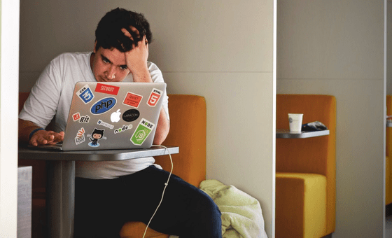 A frustrated developerl sits staring at his computer