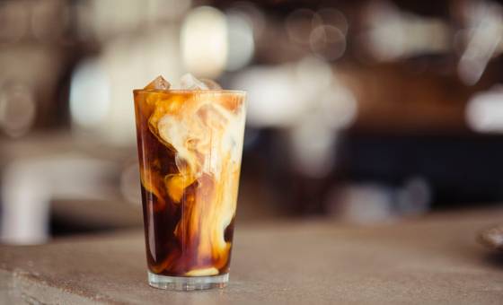 Cold latte with ice in a glass cup